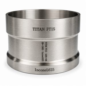 Titan-Inconel combination adapter with visible markings for titanium FT-15 and Inconel 625 and an engraved material transition.